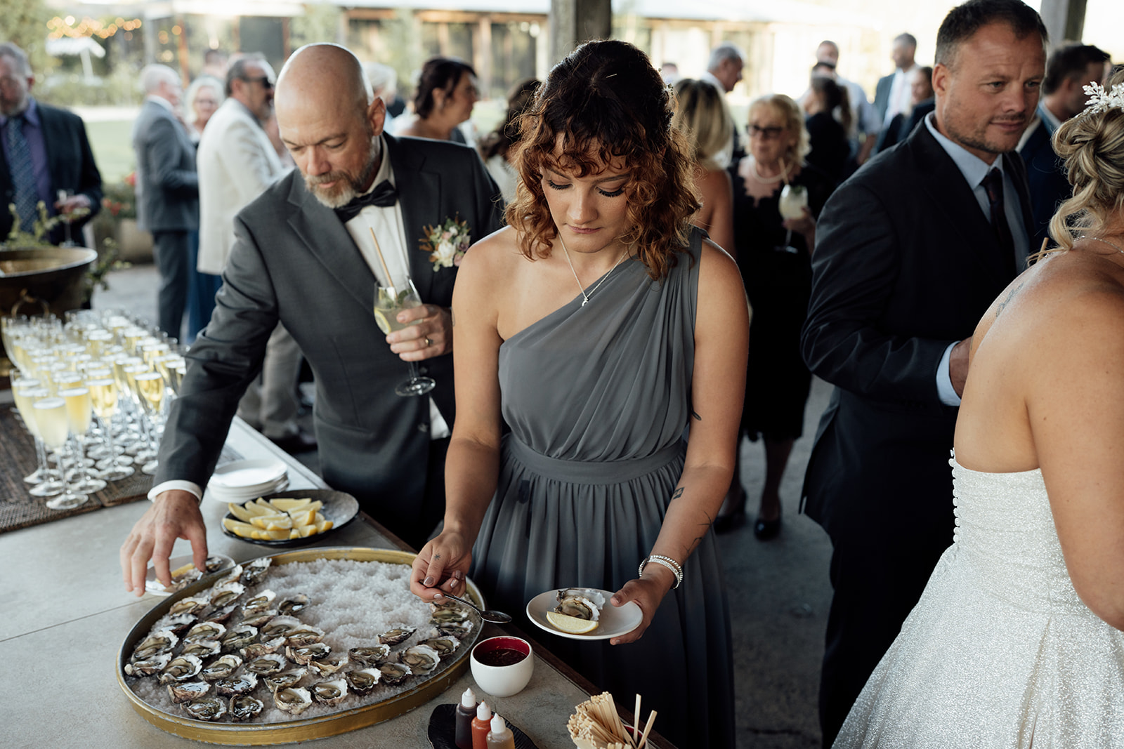 Guests at oyster table during wedding reception