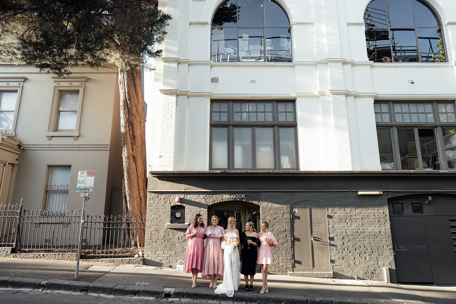 bridesmaids out the front of Panama Dining room laughing