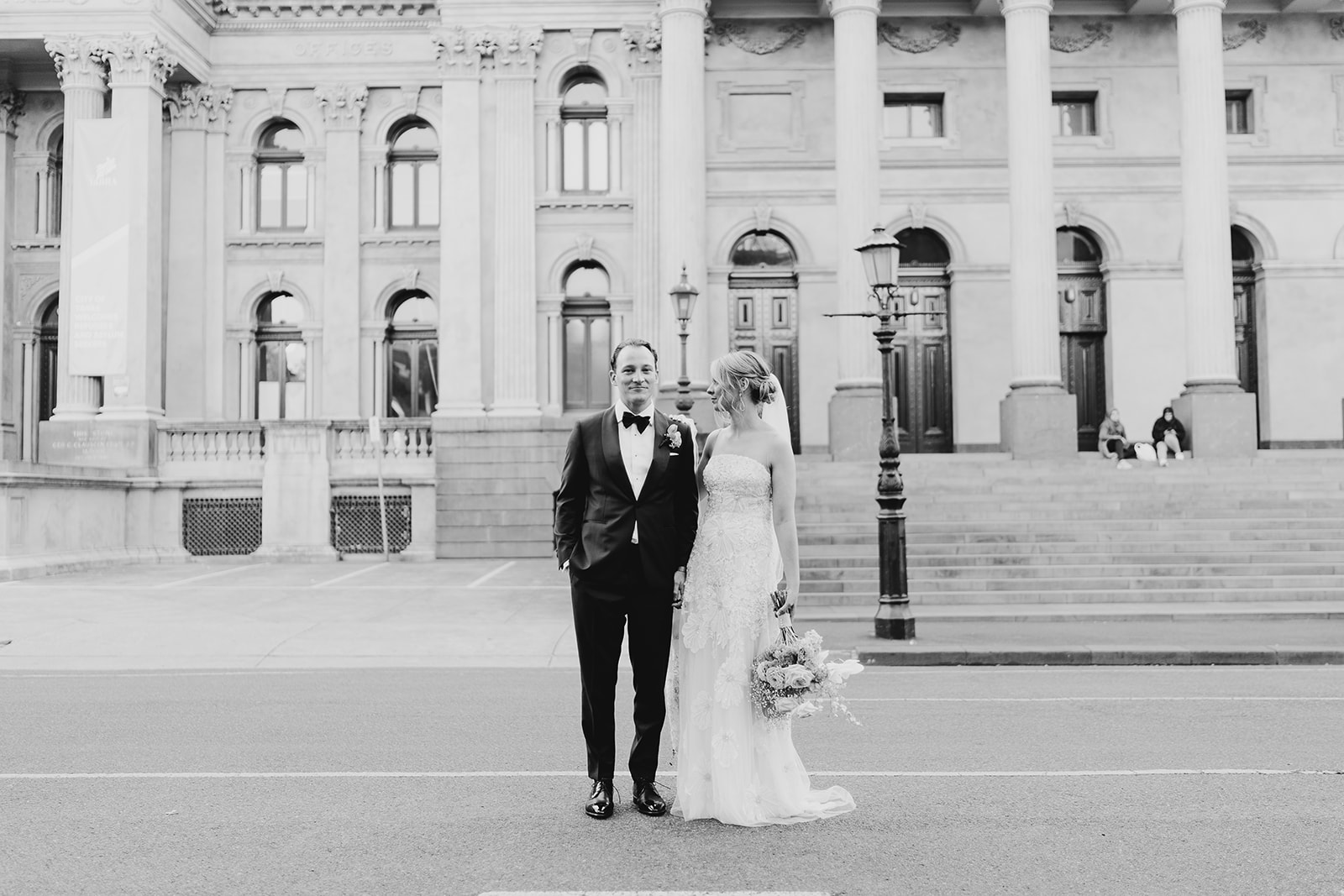 Bride and groom taking photos in the streets of collingwood