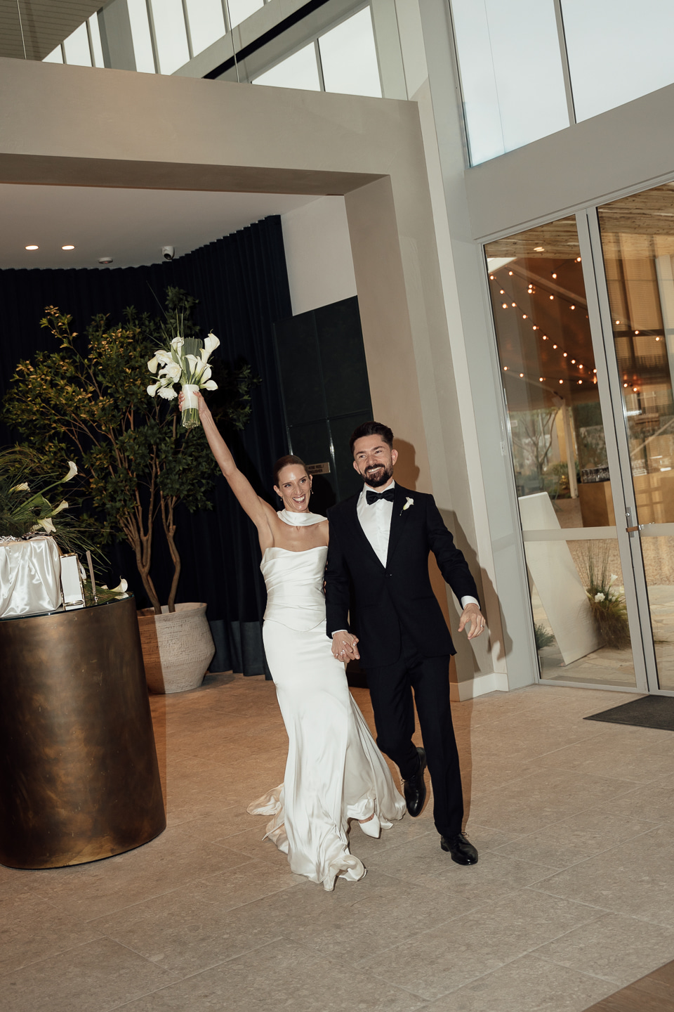 Bride and groom enter their reception in the Grand Hall at Sunnyside Estate Wedding Venue