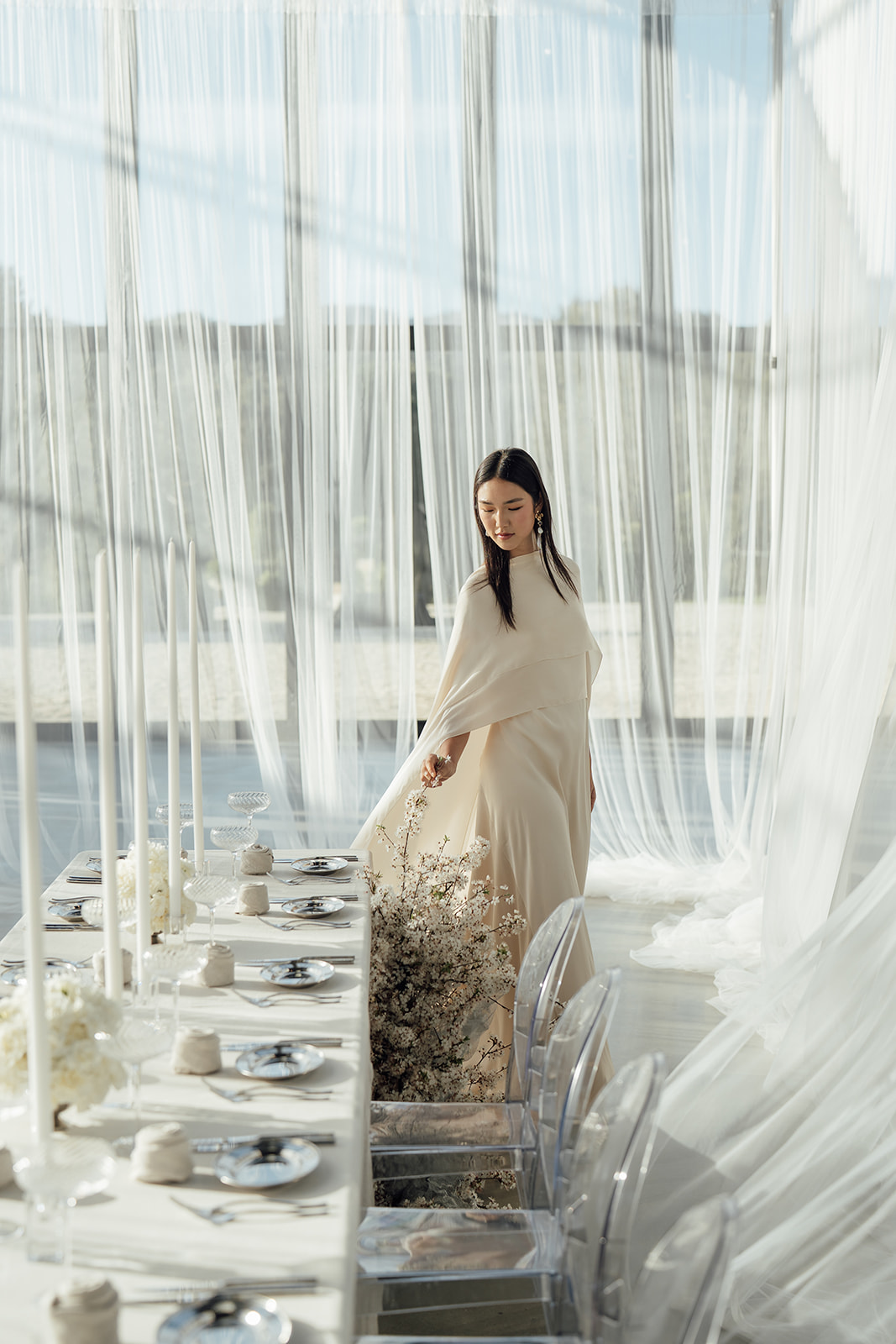 Bride walking around indoor reception table in glass atrium at Alora Macedon Venue